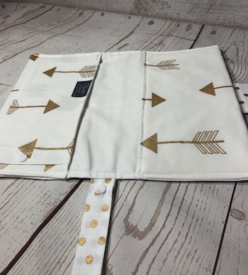 white and gold arrow nappy wallet